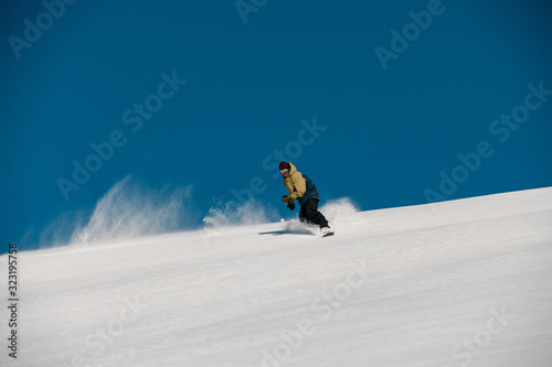 Man freerider glides down on the mountain side