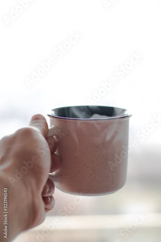 a cup on a white background in which tea is brewed
