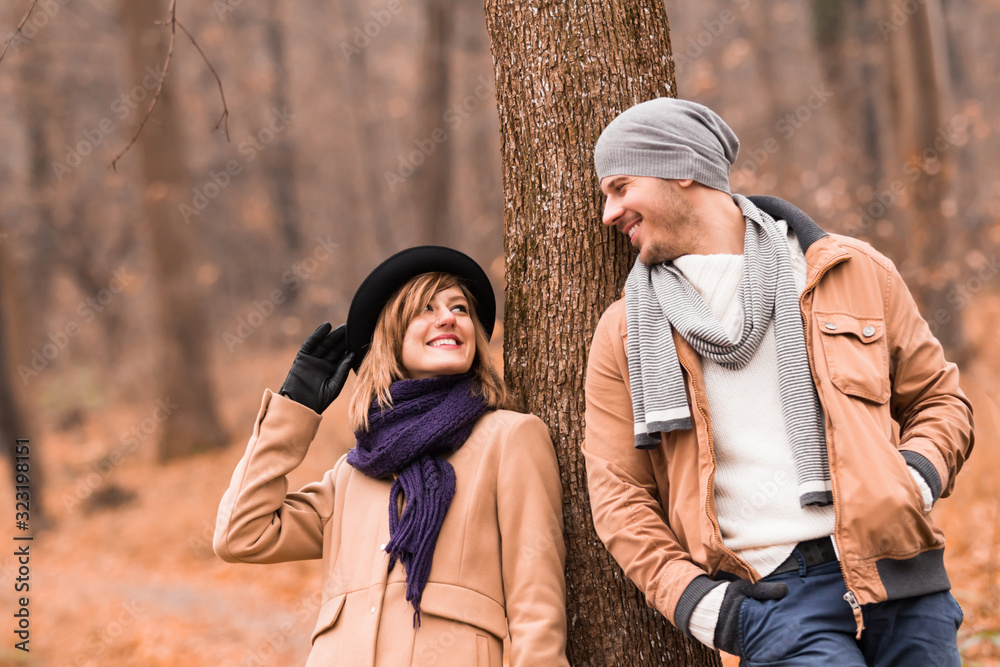 Fototapeta premium Couple in the park enjoying nice autumn / winter time.