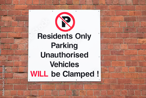 Vehicles will be clamped sign for residents only housing car park