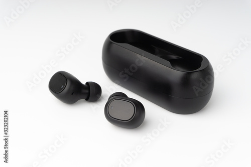 Wireless earbuds or earphones on white background. Copy space and technology concept