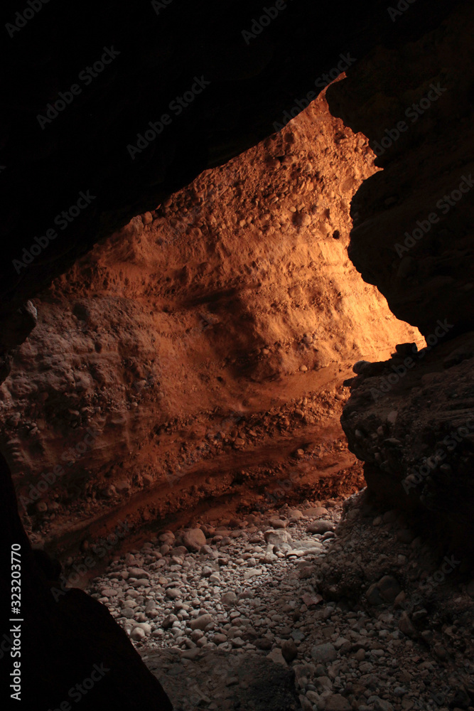Fototapeta premium Mountain water stream pathway made a cave 
