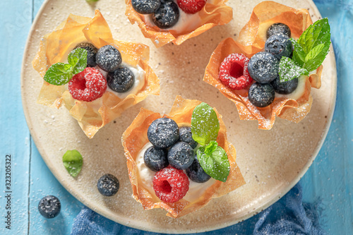 Homemade phyllo cups with fresh berries and whipped cream