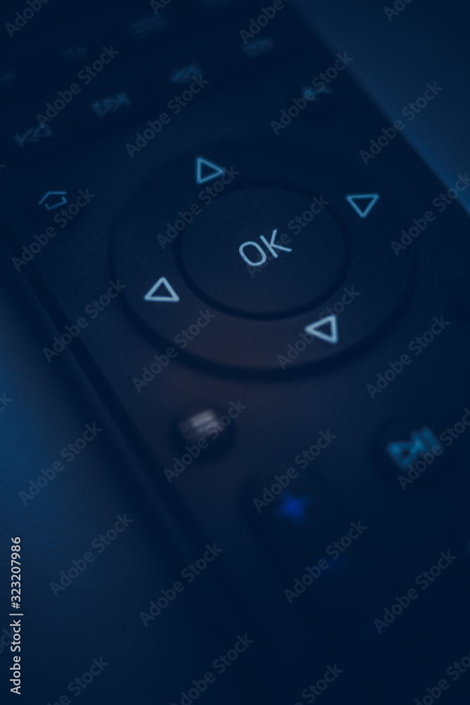 Remote control close-up. Dark blue tone. Focus on the center. Remote control close-up. Dark blue tone. Focus on the center.