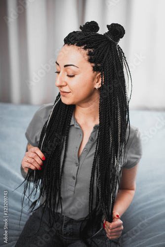 Portrait of a beautiful cool girl with Senegalese pigtails twists very cool