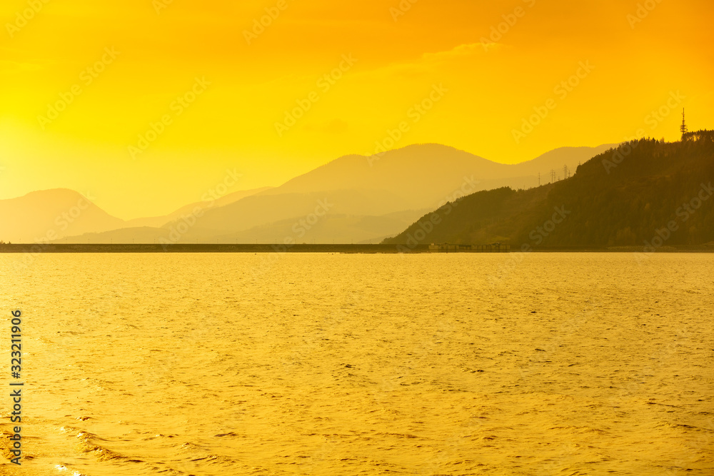 Silhouette of mountains against a golden sunset sky. Liptov sea. Nature of Slovak Republic, Europe