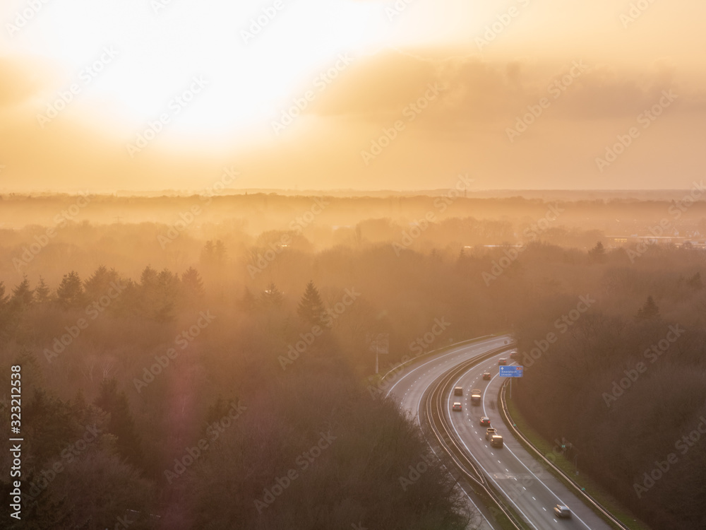 Highway Path through forest landscape with sunset background Highway Path through forest landscape with sunset background