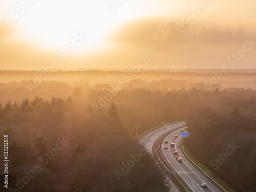 Highway Path through forest landscape with sunset background