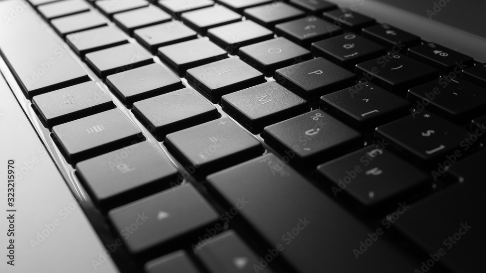 Close-up of a laptop keyboard in black and white with french layout Close-up of a laptop keyboard in black and white with french layout