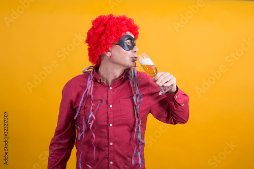 man with wig and streamers drinking fun, party concept