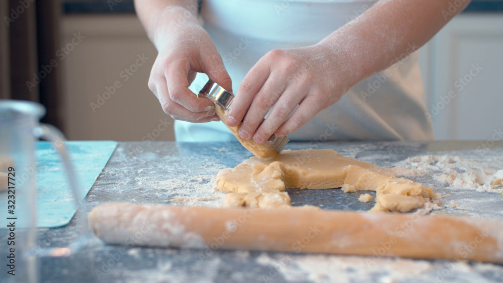 Girl making cookies with a cookie cutter Girl making cookies with a cookie cutter