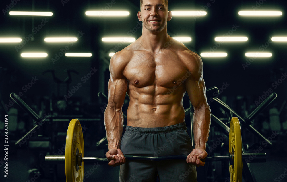 Bodybuilder strong man pumping up biceps muscles Bodybuilder strong man pumping up biceps muscles