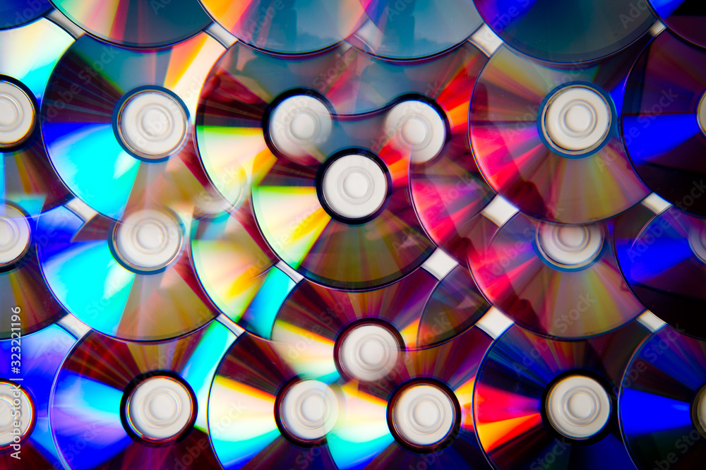 Background CD and DVD discs laid out on a flat surface. Background for saving information. Abstraction. Background CD and DVD discs laid out on a flat surface. Background for saving information. Abstraction.