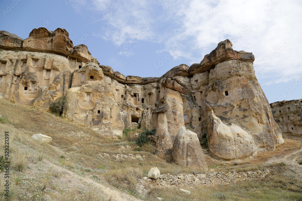 Fototapeta premium Unusual stones from volcanic rocks in the Red Valley near the village of Chavushin in the Cappadocia region in Turkey.