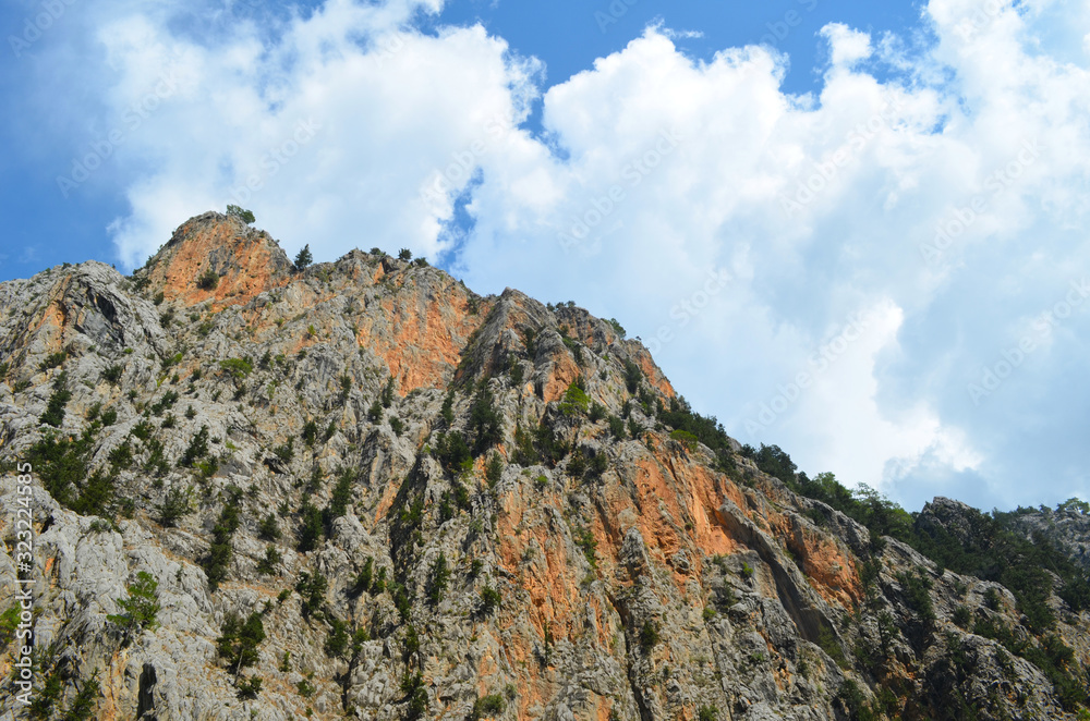 The top of the mountain on the side of the blue sky with clouds. Nature of Turkey, the Mediterranean