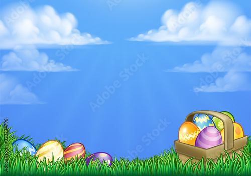 Easter background with basket or hamper full of Easter eggs in a field of grass.