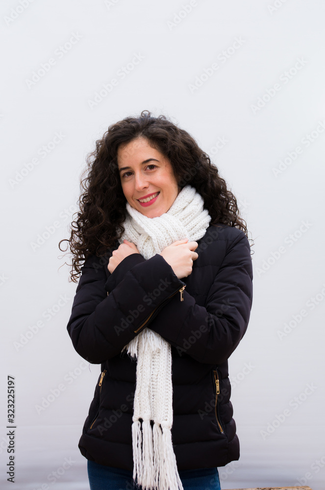young pretty woman feeling in love, smiling, cuddling and hugging self, staying single, being selfish and egocentric against white wall young pretty woman feeling in love, smiling, cuddling and hugging self, staying single, being selfish and egocentric against white wall