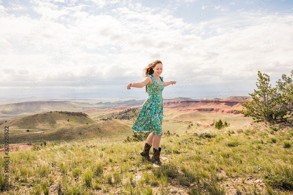 Young girl hanging out in the foothills having fun, listening to music. Bridger, Montana, USA Young girl hanging out in the foothills having fun, listening to music. Bridger, Montana, USA