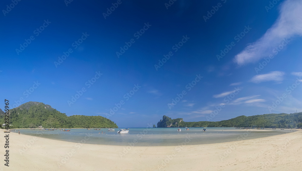 view seaside panorama on white sand beach with blue-green sea, mountains and blue sky background, Loh Dalum Bay, Phi Phi Don island, Krabi, southern of Thailand. view seaside panorama on white sand beach with blue-green sea, mountains and blue sky background, Loh Dalum Bay, Phi Phi Don island, Krabi, southern of Thailand.