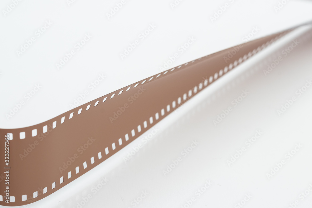 Rolled undeveloped film strip isolated white background