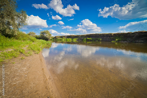 summer landscape with river sky and surrounding plants