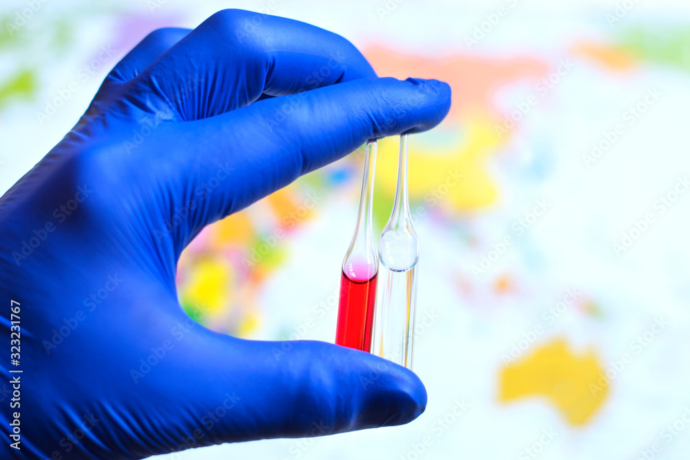 A doctor's hand holding ampoules A doctor's hand holding ampoules