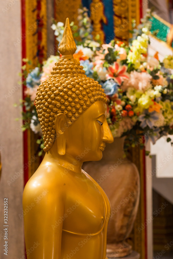 Wat Chalong, Phuket, Thailand - July 20, 2019: Hall of initiation Wat Chalong or Wat Chantharam. Gold Buddha Statue.