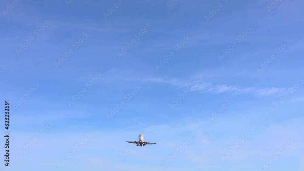 Overhead flight of modern aircraft landing in aeroport against beautifull sky. Overhead flight of modern aircraft landing in aeroport against beautifull sky.
