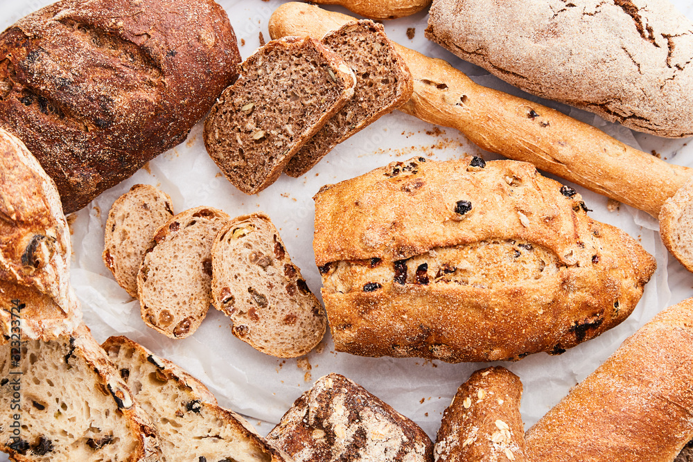 Fotografie Breads variety on a marble background viewed from above