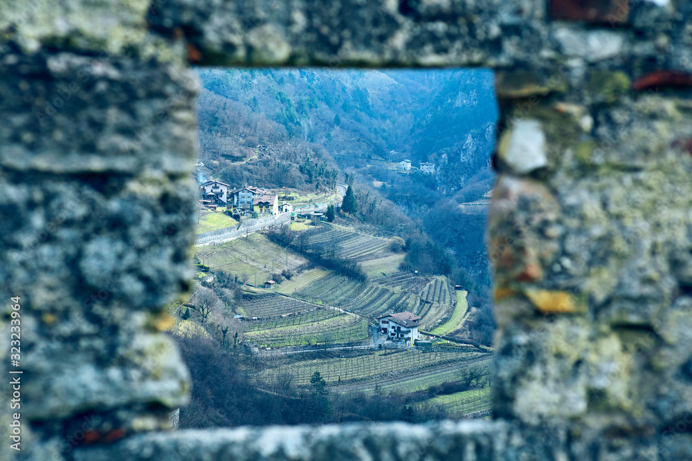 The wiew on the mountain valley throw the castle wall guard window