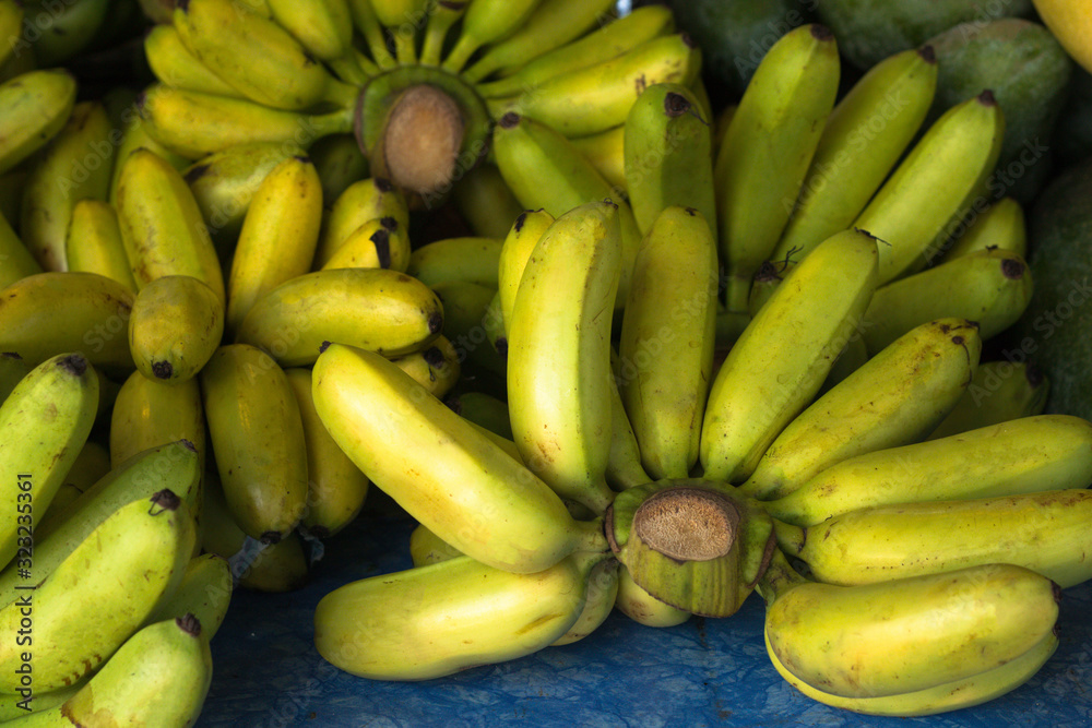 clusters of bananas are on the market counter, a healthy fruit with potassium content