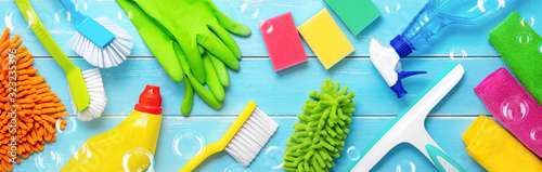 Colorfull cleaning items on blue wooden photo