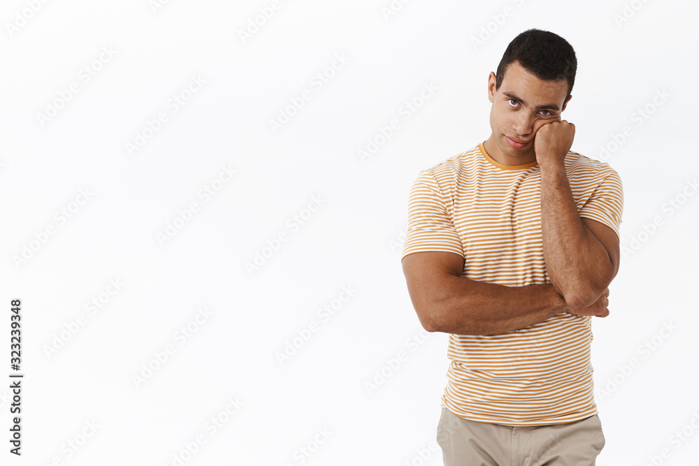Bored and unamused caucasian man standing white background reluctant, lean on fist and looking unimpressed camera, watching boring movie, too long advertisement, white background Bored and unamused caucasian man standing white background reluctant, lean on fist and looking unimpressed camera, watching boring movie, too long advertisement, white background