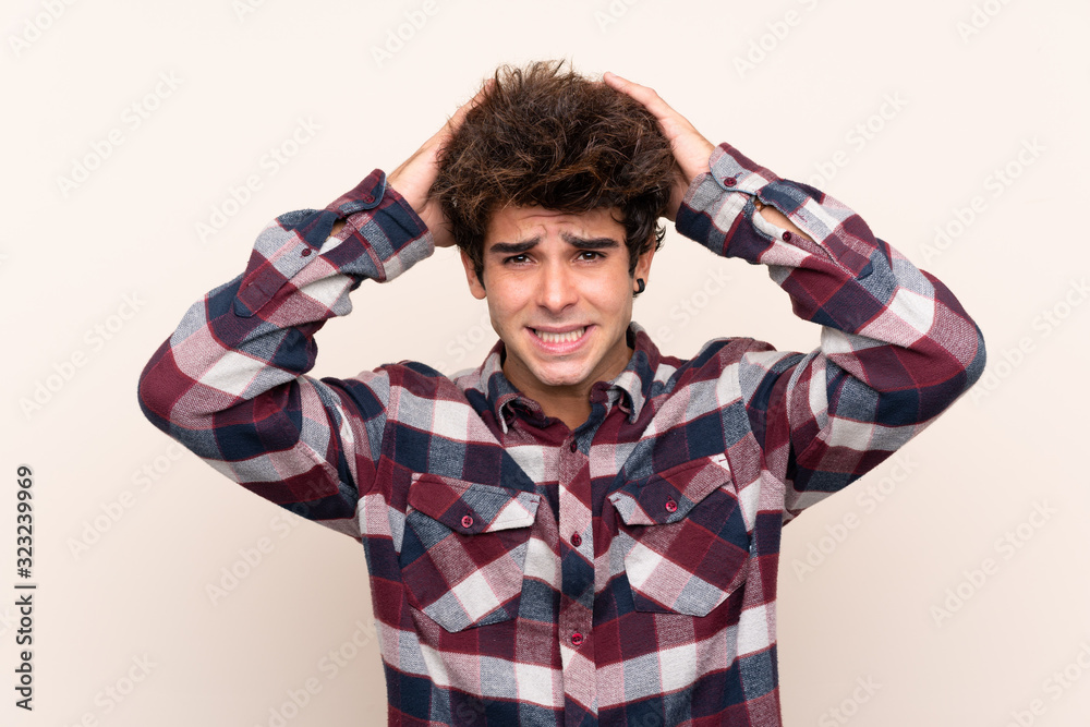 Young caucasian man frustrated and takes hands on head Young caucasian man frustrated and takes hands on head