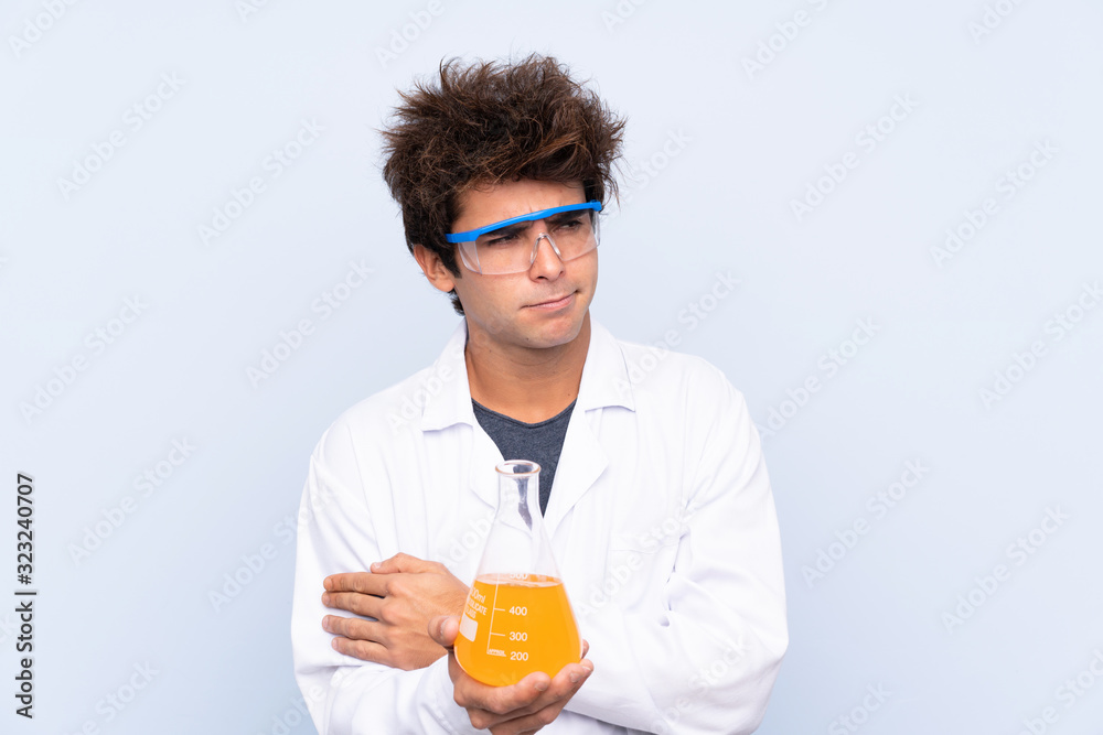 Young scientific man over isolated blue background thinking an idea