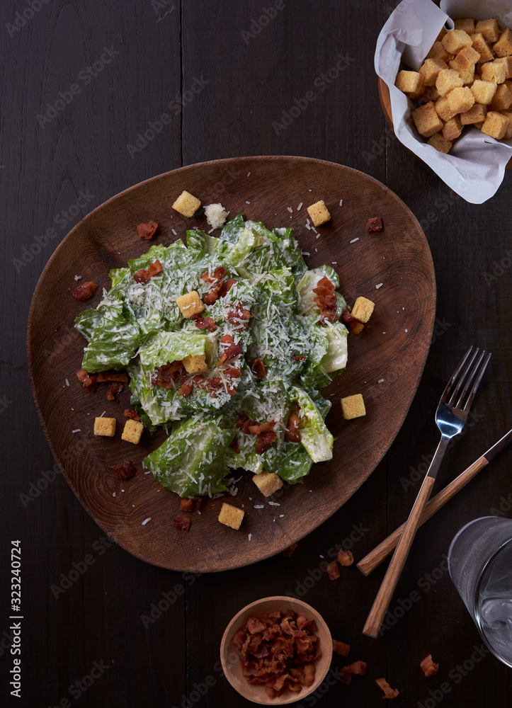 Caesar salad thai style with bacon serve with biscuits.