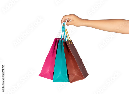Female holding multicolored shopping bags isolated on white background.