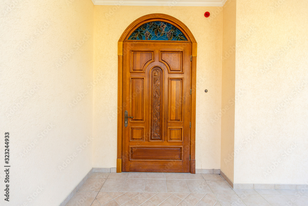entrance carved wooden door to the cottage. The door is made of wood, handmade