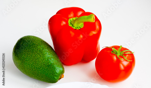 Ripe vegetables red bell pepper, tomato and avocado