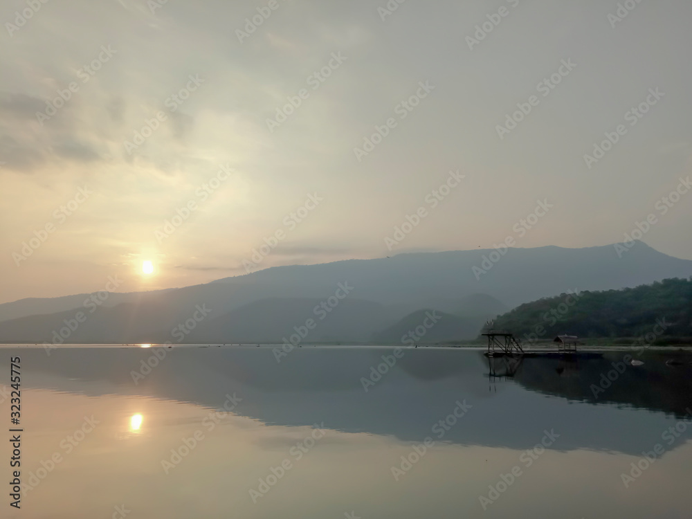 Bamboo raft floating in lake with mountain background. Lake reflection beautiful nature