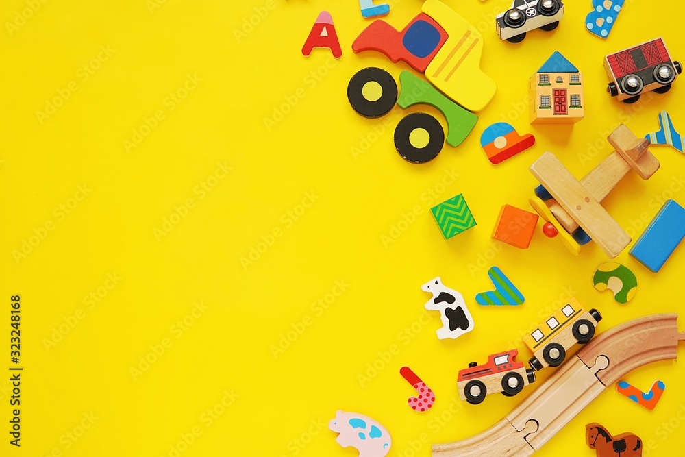 Set of colorful wooden kids toys, cars, trains, building blocks on yellow background. Set of colorful wooden kids toys, cars, trains, building blocks on yellow background.