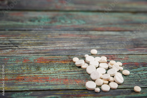 White pill on a wooden background