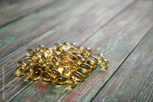Omega 3 capsules on a wooden background