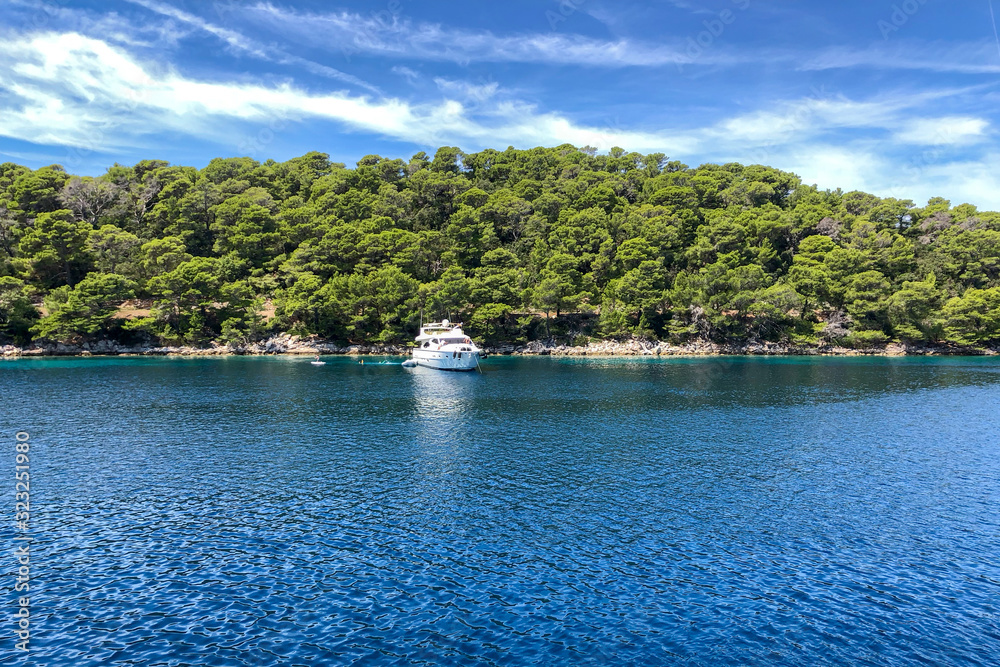 Luxury motoryacht moored in wonderful bay with turquoise water