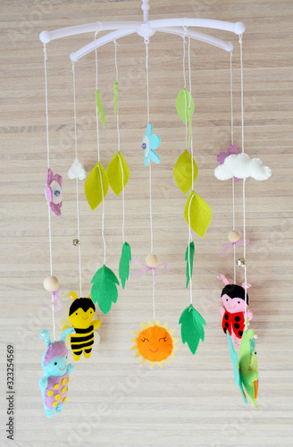 Mobile for crib with different toys in the form of bugs. Handmade toy from felt
