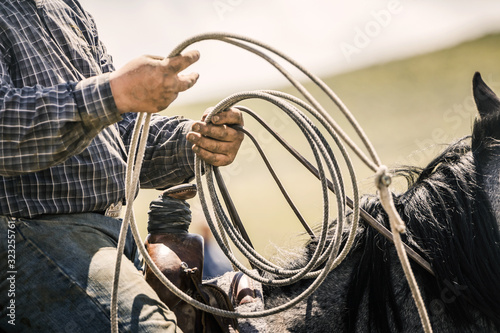 Close-up of cowboy holding his lasso ready in hand. Cody, Wyoming, USA photo