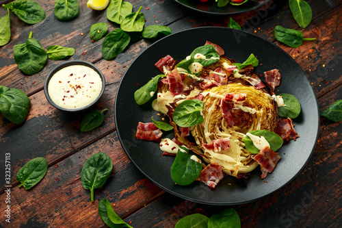 Oven roasted cabbage steaks with bacon, spinach and mayonnaise. healthy food