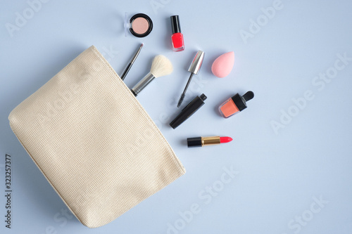 Fotografie Make-up cosmetic bag on blue background