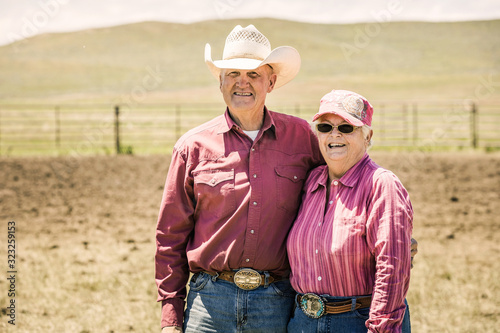 Portrait of western couple in the pen after a branding. Cody, Wyoming, USA photo