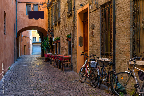 Fototapeta Naklejka Na Ścianę i Meble -  Cozy narrow street in Ferrara, Emilia-Romagna, Italy. Ferrara is capital of the Province of Ferrara